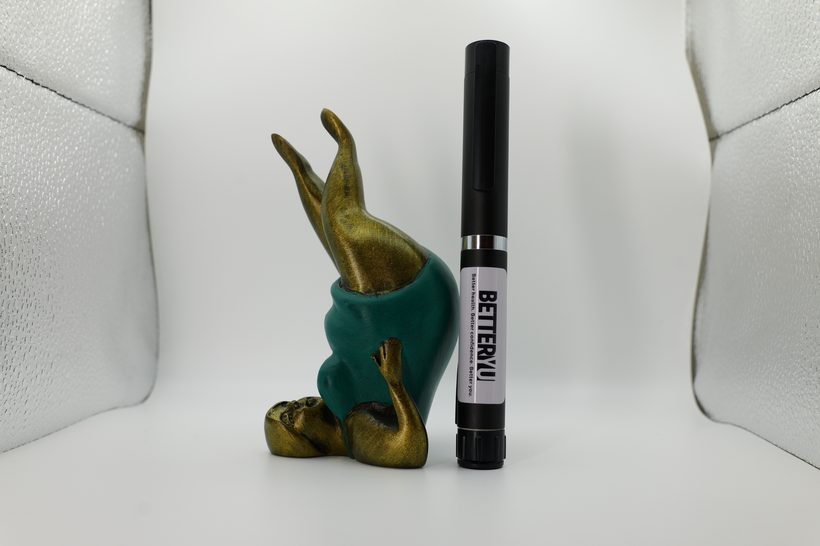 A pre-measured injection pen resting on a soft neutral surface, illustrating provider-guided gut health support